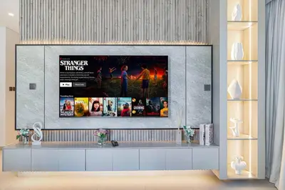 a living room with a flat screen tv on a wall at Mahogany 23 - 2BR 10PAX - Burj Khalifa View Central in Dubai