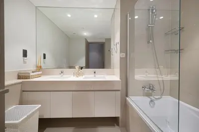 a bathroom with two sinks and a shower at Mahogany 23 - 2BR 10PAX - Burj Khalifa View Central in Dubai