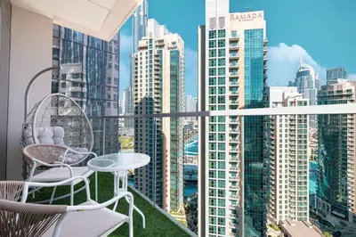a balcony with a table and chairs and a city at Mahogany 23 - 2BR 10PAX - Burj Khalifa View Central in Dubai