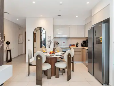 a kitchen and dining room with a table and chairs at New-Best Burj Khalifa View I 2BR I Walk DubaiMall in Dubai