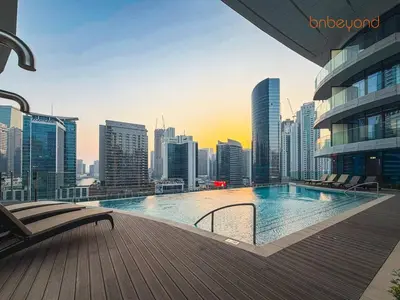 a swimming pool on a building with a city skyline at 3BR Skyline Burj Panorama with Infinity Pool Vibes in Dubai