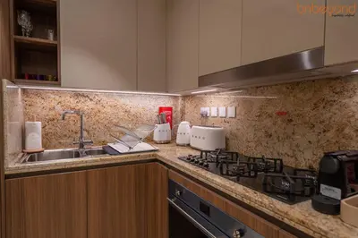 a kitchen with a sink and a counter top at 3BR Skyline Burj Panorama with Infinity Pool Vibes in Dubai