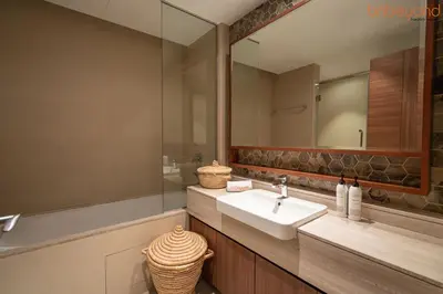 a bathroom with a sink and a mirror at 3BR Skyline Burj Panorama with Infinity Pool Vibes in Dubai