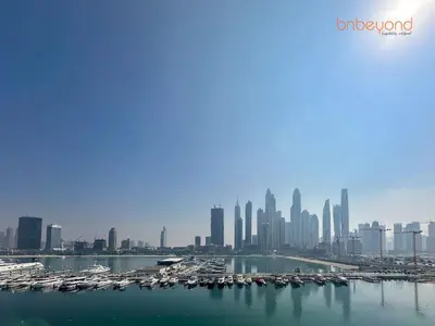 a view of a city skyline with boats in the water at Beach vibes with Serene views in Dubai