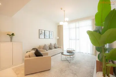 a living room with a couch and a table at Beach vibes with Serene views in Dubai