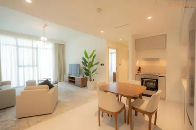 a living room with a wooden table and chairs at Beach vibes with Serene views in Dubai