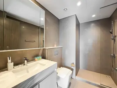 a bathroom with a sink and a shower and a toilet at Full Burj Khalifa & Fountain Views - Luxury 2BR in Downtown Dubai in Dubai