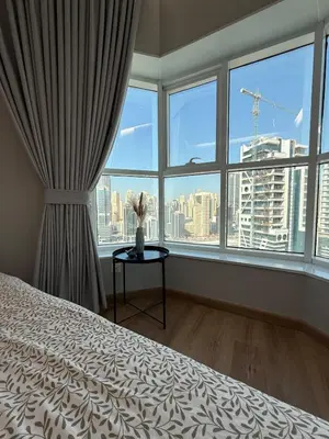 a bedroom with a bed and a large window at ZenStay - Charming Studio in JLT, near JBR &Marina in Dubai