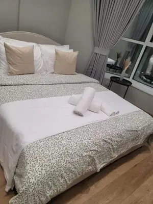 a white bed with two pillows on top of it at ZenStay - Charming Studio in JLT, near JBR &Marina in Dubai