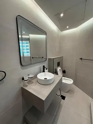 a bathroom with a sink and a mirror and a toilet at ZenStay - Charming Studio in JLT, near JBR &Marina in Dubai