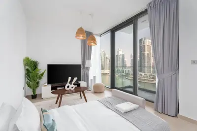 a bedroom with a large window with a view of the city at Gala Guests - LIV Contemporary Marina View Apartment Collection in Dubai