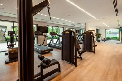 a gym with a row of tread machines in a room at Burj Royale Luxury 3BR Apartment in Dubai