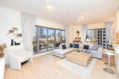 a living room with a couch and a table at South Ridge By Luxe Living - Full Burj Khalifa View in Dubai