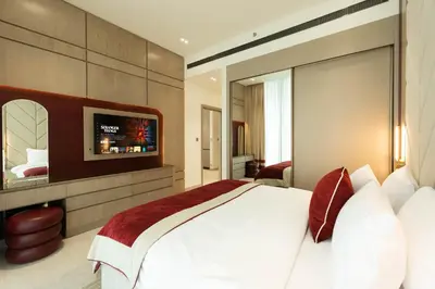 a bedroom with a large bed and a flat screen tv at Elegant 1BR Apartment in Binghatti Royale with Balcony in Dubai