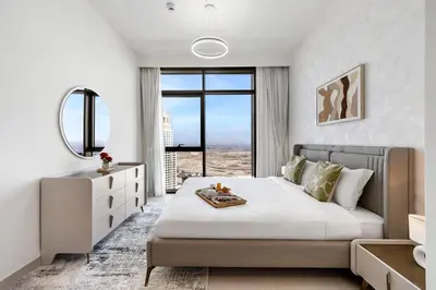 a bedroom with a large bed and a large window at BLVD-Manhattan Vibes 4BR High Floor Creek in Dubai