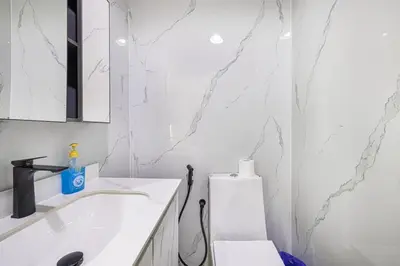 a white bathroom with a sink and a toilet at Luxury 3 BHK in Dubai Marina DEC 1402 T2 in Dubai