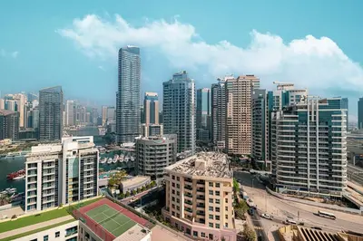 a city skyline with tall buildings and a tennis court at Luxury 3 BHK in Dubai Marina DEC 1402 T2 in Dubai