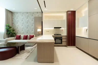 a kitchen and living room with a couch and a table at Premium 1BR Suite at Binghatti Royale with City Views in Dubai