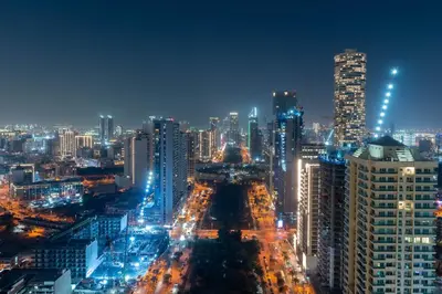 a city lit up at night with buildings at Stylish 1BR Residence in Binghatti Royale with Balcony in Dubai