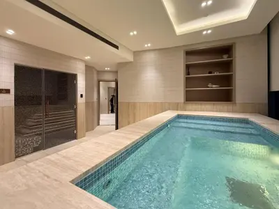 a swimming pool in a bathroom with a walk in shower at Stylish 1BR Residence in Binghatti Royale with Balcony in Dubai