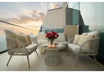 a balcony with chairs and a table on a ship at Stylish 1BR Residence in Binghatti Royale with Balcony in Dubai