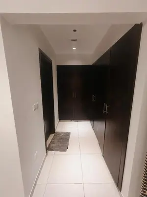 a hallway with black doors and a carpet at 2 Bedroom Furnished Apartment in Dubai