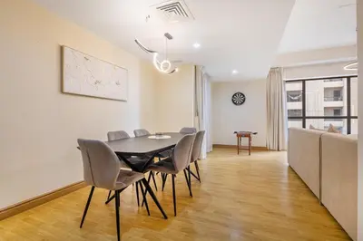 a dining room with a table and chairs at 2BR Beach Side Lux JBR Retreat - Luxury Pool Bahar in Dubai