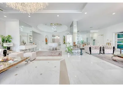 a large living room with white furniture and a chandelier at Signature Palm Villa Ultra-Luxury 5 BDR Retreat in Dubai