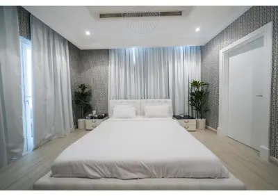 a bedroom with a large white bed in it at Signature Palm Villa Ultra-Luxury 5 BDR Retreat in Dubai
