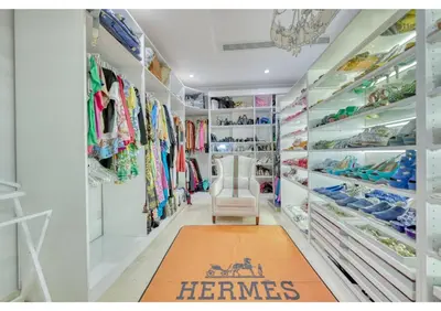 a walk in closet with a chair and a rug at Signature Palm Villa Ultra-Luxury 5 BDR Retreat in Dubai