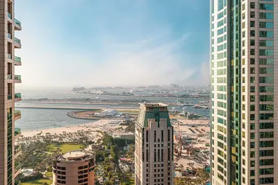 a view of a city with tall buildings and a beach at 2BR Near to Beach JBR Dubai Eye & Sea View SV 2805 in Dubai