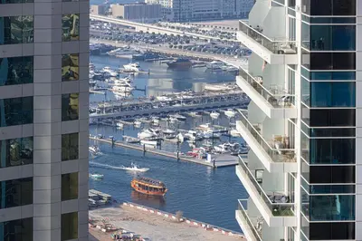 a view of a marina between two buildings at 2BR Near to Beach JBR Dubai Eye & Sea View SV 2805 in Dubai
