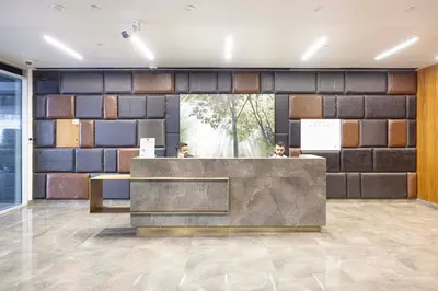 a lobby with two people sitting at a reception desk at 2BR Near to Beach JBR Dubai Eye & Sea View SV 2805 in Dubai