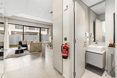 a living room with a fire extinguisher in a house at Family 4BR Villa | PS5 & Garden | New Community in Dubai