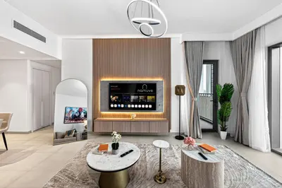 a living room with a fireplace with a tv at 2BR Burj View - Downtown Views 2 - Dubai Mall Access in Dubai