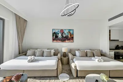 a living room with two beds and a couch at 2BR Burj View - Downtown Views 2 - Dubai Mall Access in Dubai