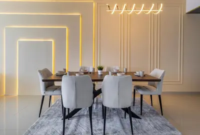 a dining room with a wooden table and chairs at Luxury 3 BR in Dubai Marina By dPie DEC 2003 in Dubai