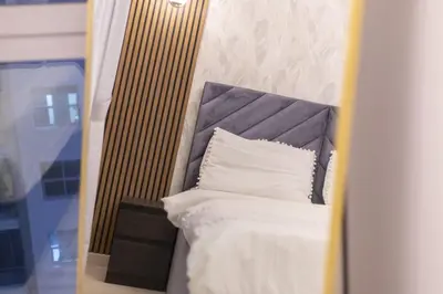 a bed with a headboard and white pillows at Luxury 3 BR in Dubai Marina By dPie DEC 2003 in Dubai
