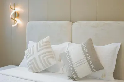 a bed with white pillows on top of it at Luxury 3 BR in Dubai Marina By dPie DEC T1 503 in Dubai
