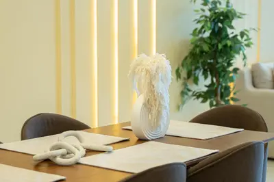 a wooden table with a vase on top of it at Luxury 3 BR w Private Jacuzzi in Marina DEC 2203 in Dubai