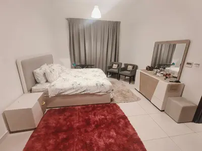 a bedroom with a bed and a vanity and a mirror at Private Room with Bath in Dubai