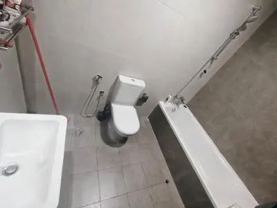 a bathroom with a white toilet and a sink at Private Room with Bath in Dubai