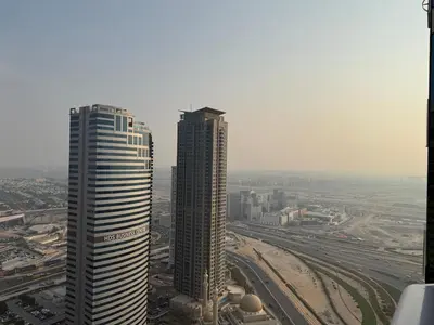 two tall buildings in a city next to a highway at Zenstay-Modern 2BR in JLT-Near Marina& Metro in Dubai