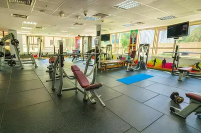 a gym with several tread machines and a flat screen tv at Luxury Marina View 2BR Apartment for 6 in Dubai