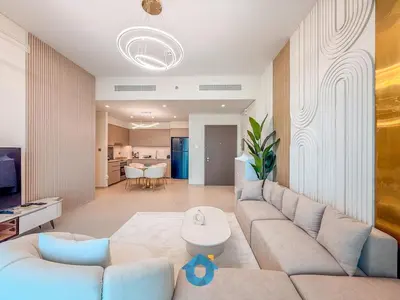 a living room with a couch and a table at Wake up To Burj Khalifa Views Luxury 2 BR LikeHome in Dubai