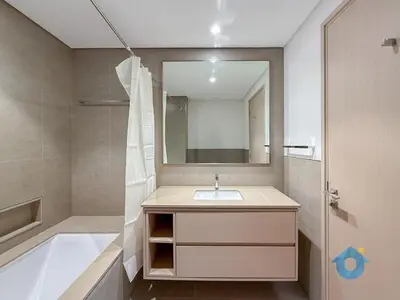 a bathroom with a sink and a tub and a mirror at Wake up To Burj Khalifa Views Luxury 2 BR LikeHome in Dubai