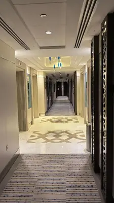an empty hallway in a building with a rug on the floor at Damac Maison The Distinction 1 BHK Burj Khalifa in Dubai