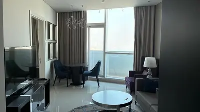 a living room with a couch and a table at Damac Maison The Distinction 1 BHK Burj Khalifa in Dubai