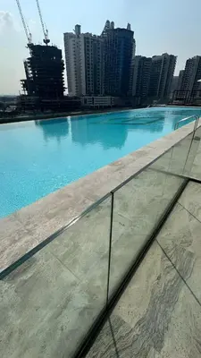a large swimming pool in a city with tall buildings at Luxury Studio with Private Jacuzzi at Trillionaire, Business Bay in Dubai
