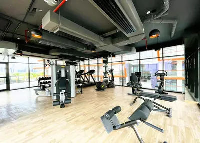 a gym with several treadmills and cardio machines at Modern 1BR with Pool & Gym, Burj Khalifa View, Al Jaddaf in Dubai